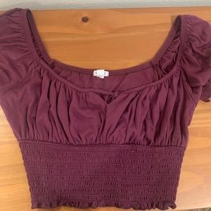 Garage crop top with subtle detailed design.